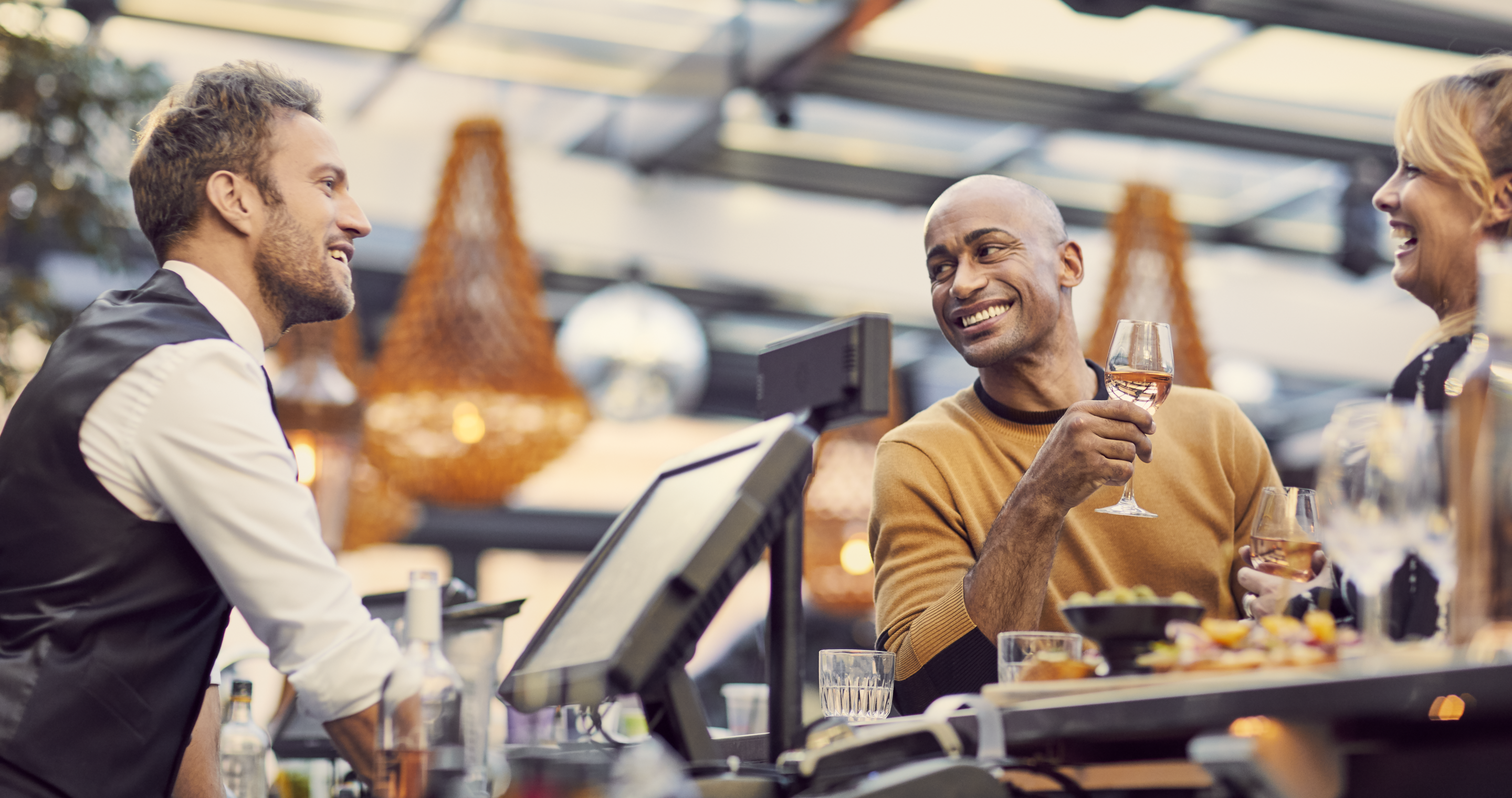 Guests talking with bartender