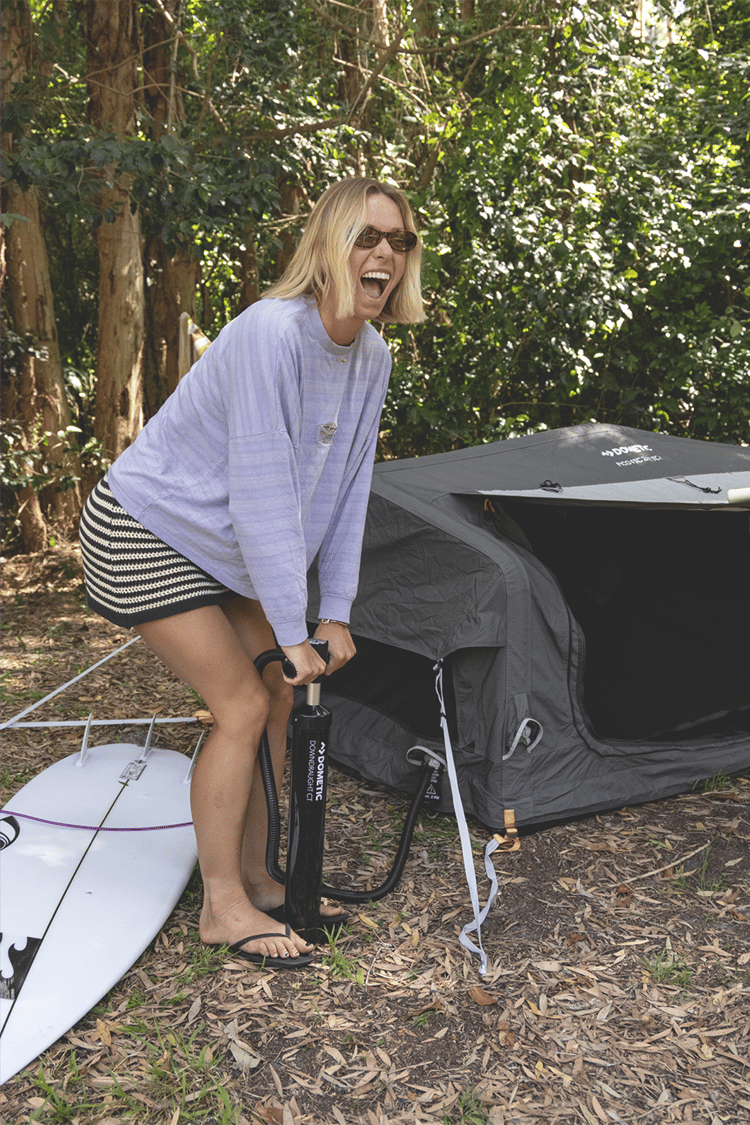 Macy pumps up her Pico swag tent ready for a surf camp out