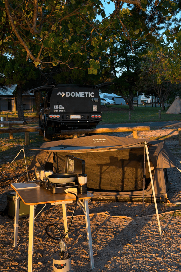 Harry Holland's Dometic camp set up is complete, featuring a Pico Swag, Camp table and cooker. With the golden glow of sunset reflecting he's in for a nice night under the stars..