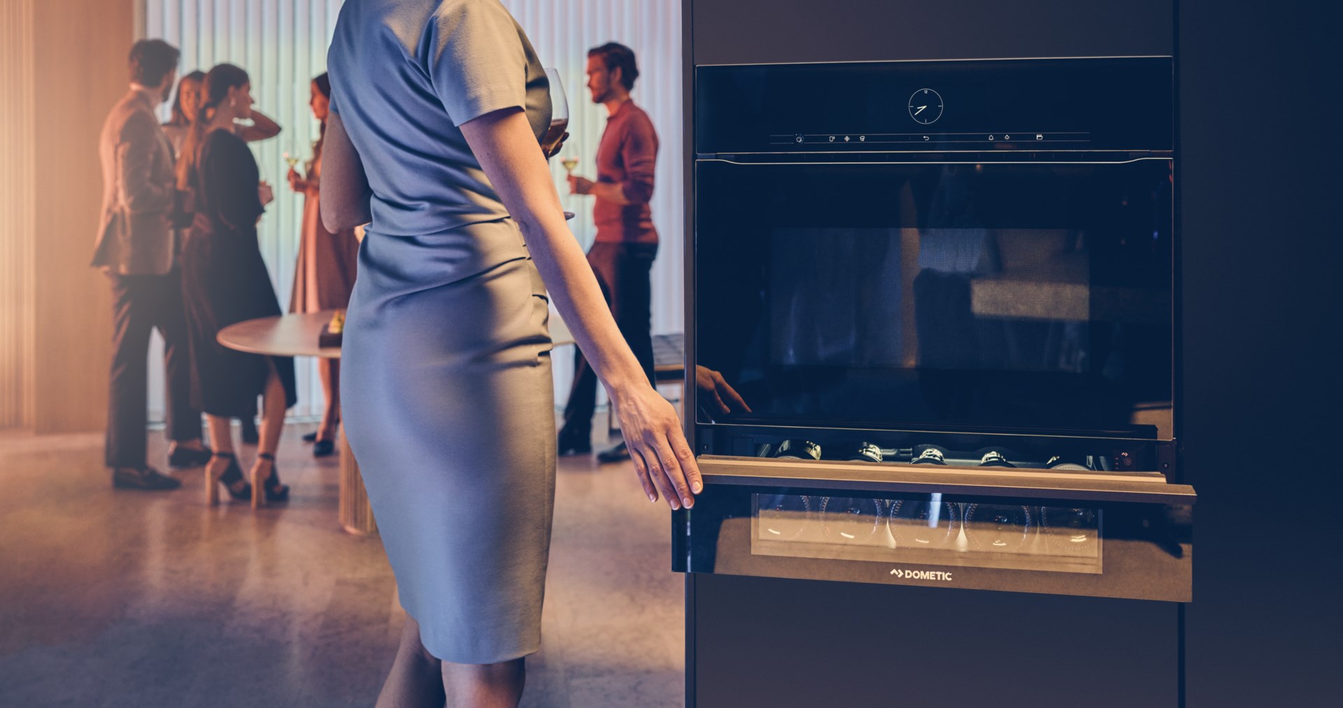 Woman at a party closing wine drawer.