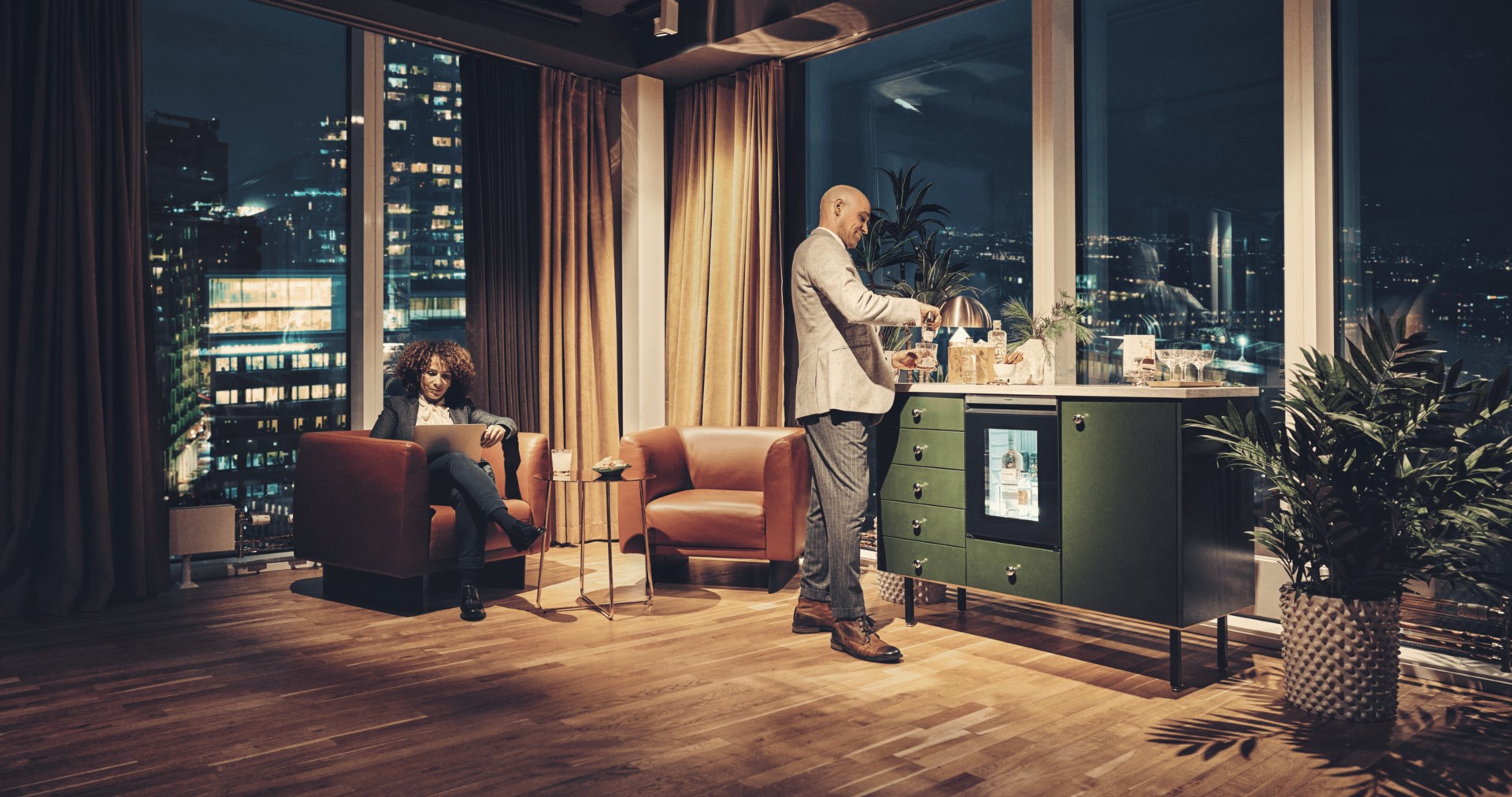 Man and woman in a hotel room, using the Dometic HiPro Minibar