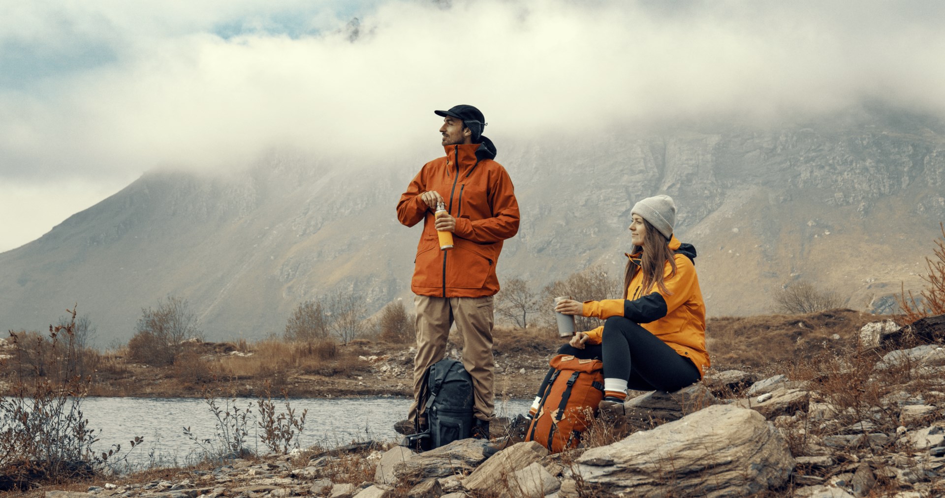 Man and woman stare into the distance while taking a hiking break
